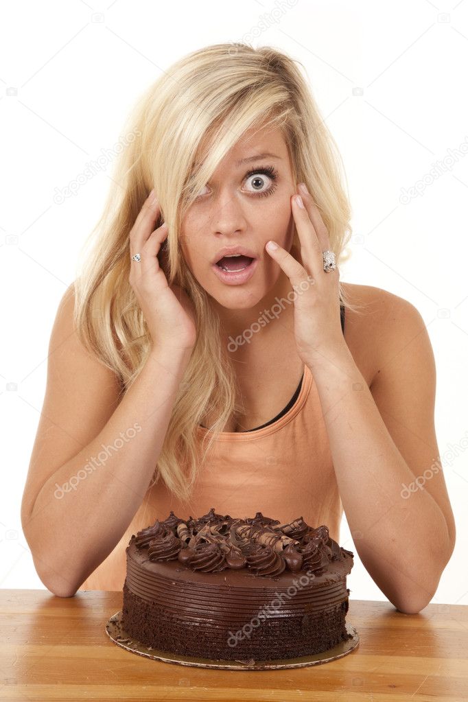 Woman wtih cake and shocked expression