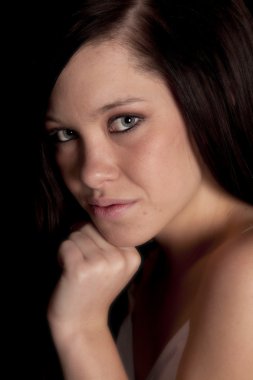 Portrait woman dark hair hand chin