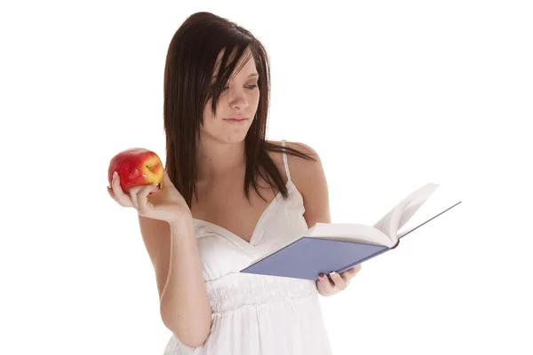 Reading book holding apple — Stock Photo, Image