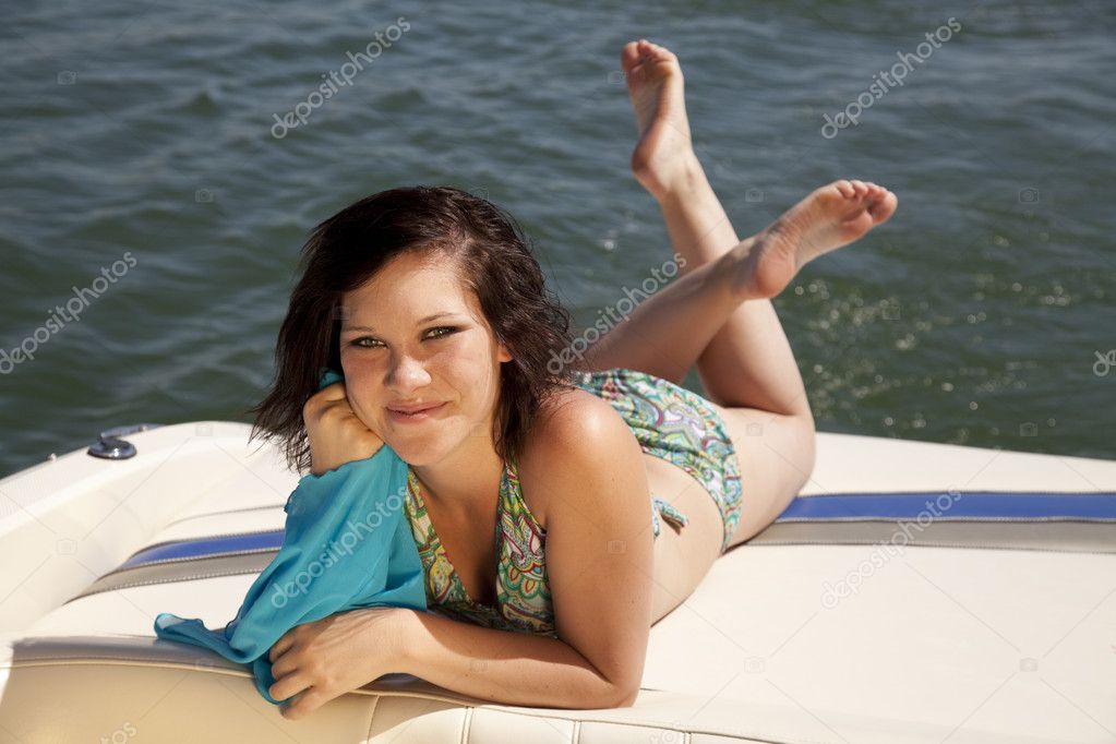 Woman bikini boat lay facing