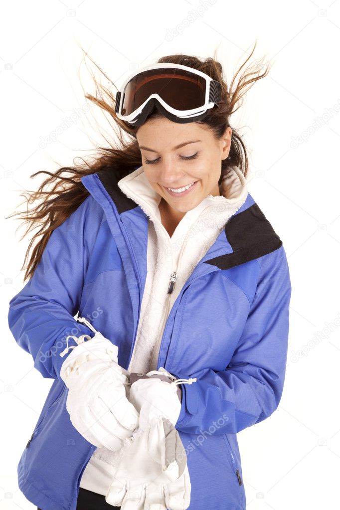 Woman ski jacked put gloves