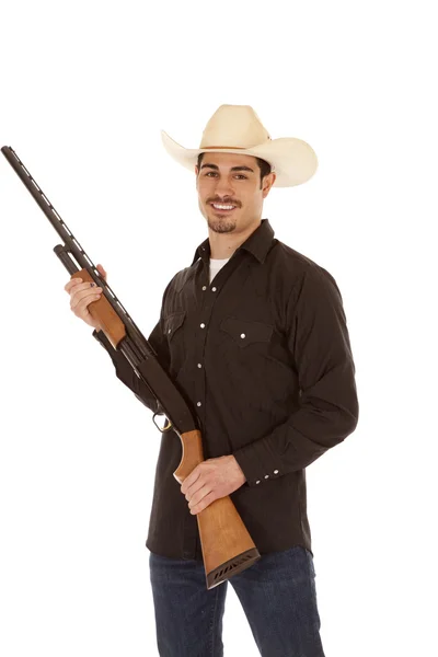 Cowboy segurando espingarda sorriso — Fotografia de Stock