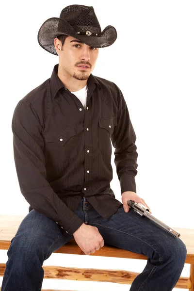 stock image Cowboy sitting with gun on leg