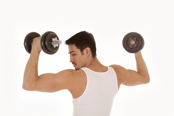Man from back lifting weights looking shoulder — Stock Photo, Image