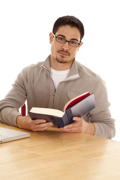 Man looking up from book — Stock Photo, Image