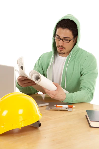 Man reading plans in green — Stock Photo, Image