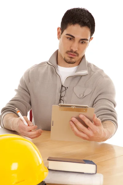 Man surprised looking at clipboard — Stock Photo, Image