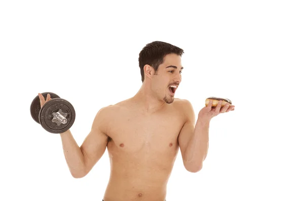 Man with weight and donut — 스톡 사진