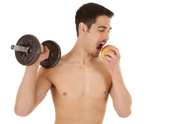 Man with weight eating apple — Stock Photo, Image
