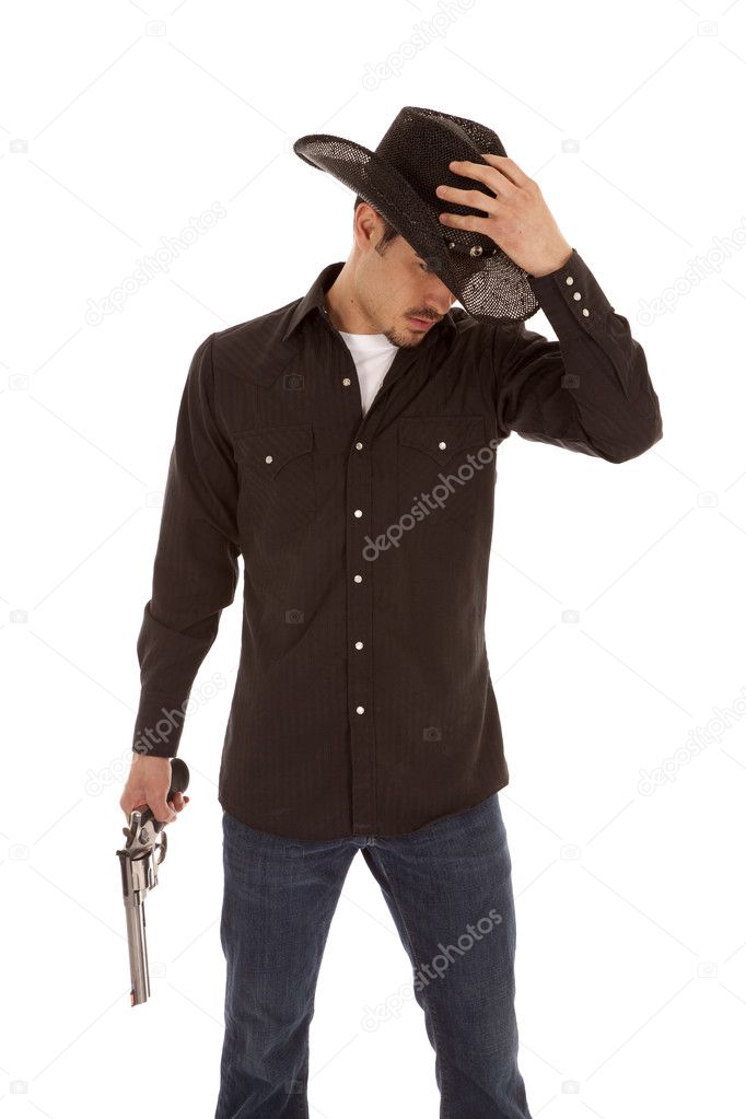 Cowboy holding hat and gun