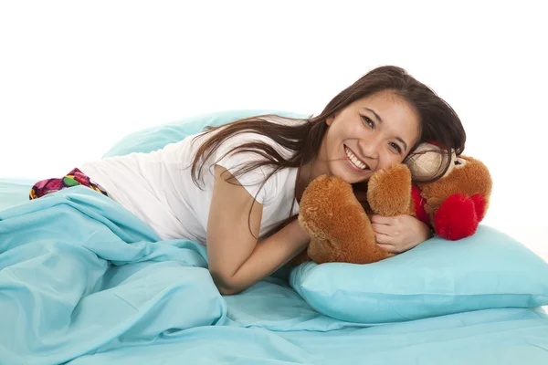 Woman in bed with bear laying on — Stock Photo, Image