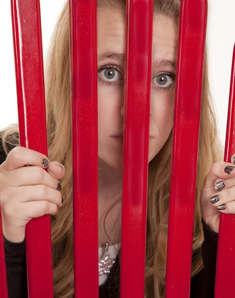 Dívka při pohledu přes mříže — Stock fotografie