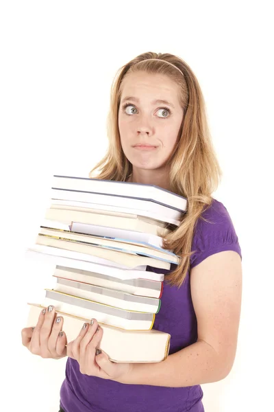 Dziewczyna stos książek wygląd strony — Zdjęcie stockowe