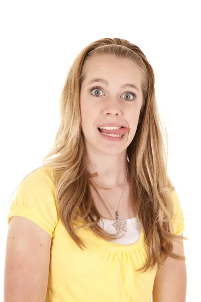 Girl yellow shirt tongue — Stock Photo, Image