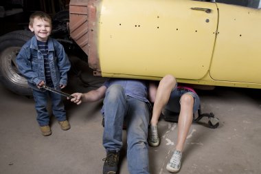 Son handing father a tool clipart