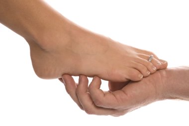 Man holding woman feet clipart