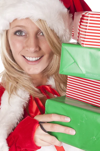 Santas helper peeking around presents — Stock Photo, Image