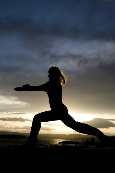 Woman silhouette doing yoga — Stok fotoğraf