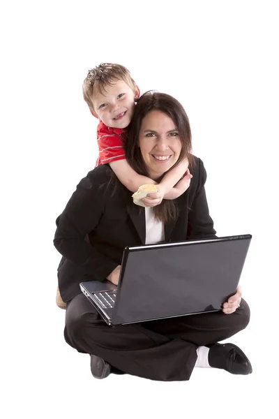 Woman working and son on neck. — Stock Photo, Image