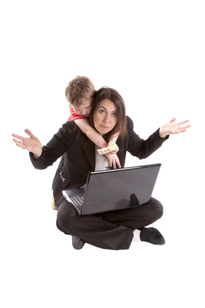 Woman working frustrated with son — Stock Photo, Image