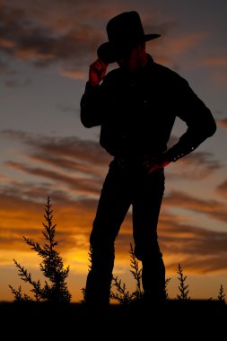 Cowboy silhouette hold hat clipart