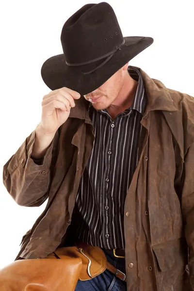 Cowboy leaning over touching hat — Stock Photo, Image