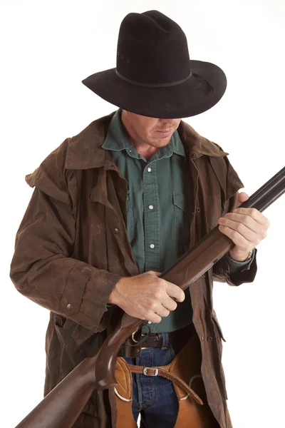 Cowboy looking down at shotgun — Stock Photo, Image