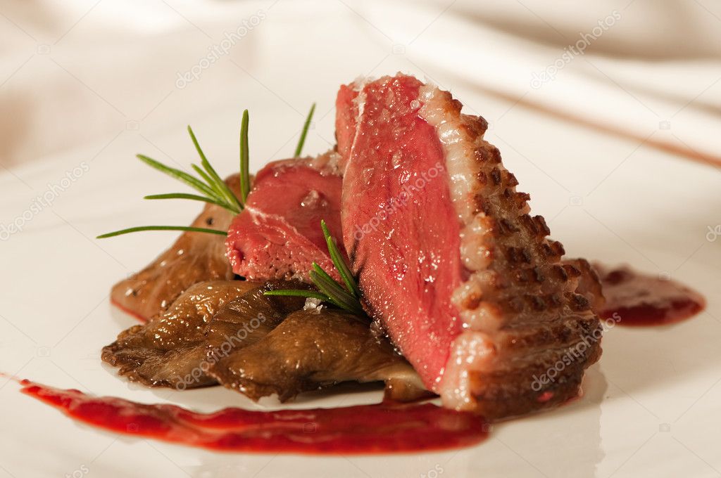 Duck breast with raspberry sauce and mushrooms
