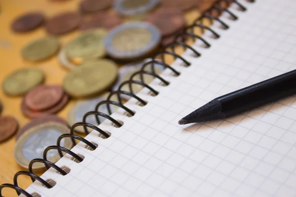 stock image Pencil on notebook and money