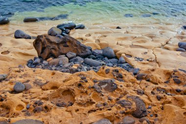 Beach-with-Stones-Lava-and-Unusual-hardened-Sand-in-Sunset-Light