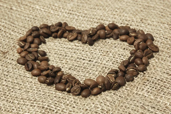 Corazón de café sobre lienzo —  Fotos de Stock