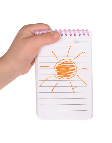 Children's hand hold notebook with a painted sun — Stock Photo, Image
