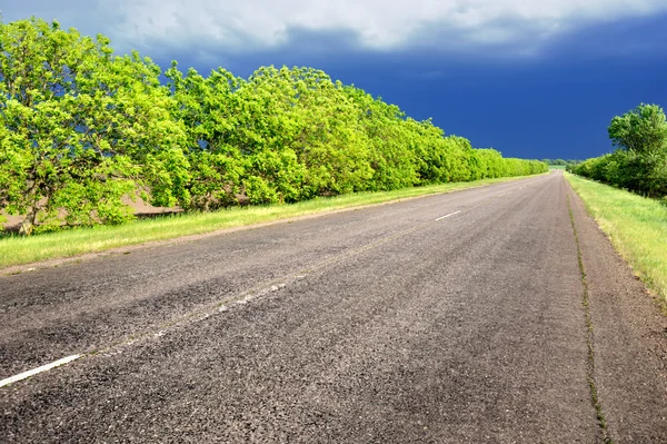 Landscape with road and dark sky — Stock Photo, Image