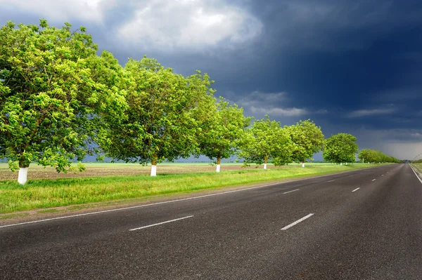 Landscape with road and dark sky — Stock Photo, Image