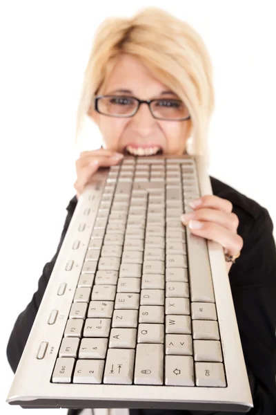 Mulher mordendo teclado — Fotografia de Stock