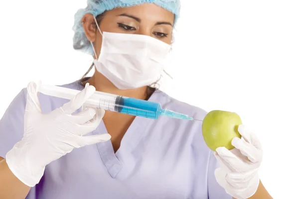 Researcher injecting liquid in apple — Stock Photo, Image
