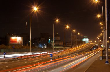 The bridge of a traffic interchange at night clipart