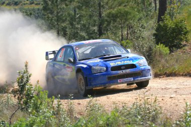 Subaru world rally car competing on the Portugal Rally 2007 clipart