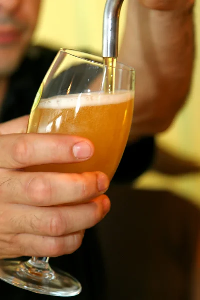 stock image Pouring beer on a glass