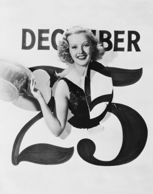 Woman bursting through calendar on Christmas day clipart
