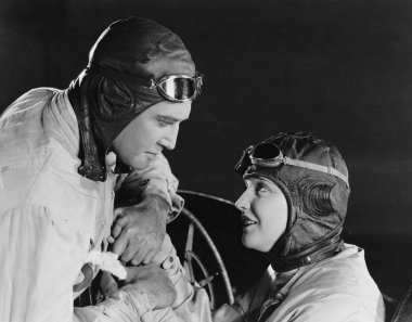 Couple in racing hats and goggles clipart