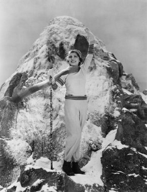 Triumphant woman at mountain summit clipart