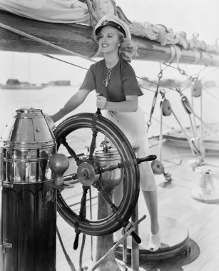 Portrait of woman steering boat clipart