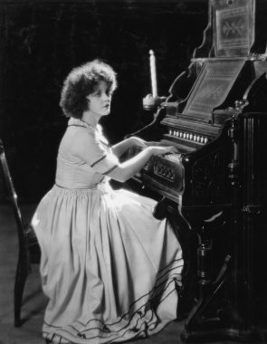 Portrait of woman playing organ clipart