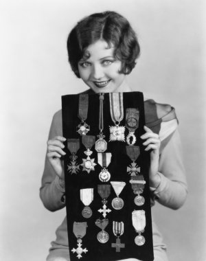 Woman holding display of medals clipart