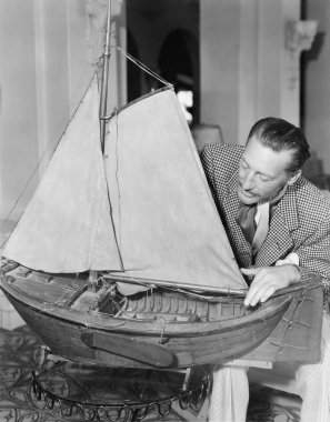 Man with model ship clipart
