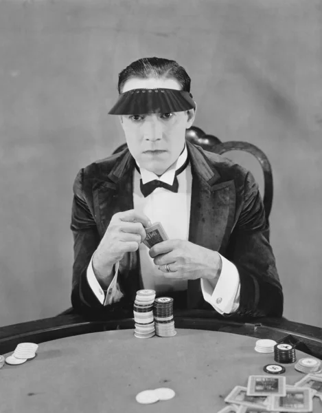 stock image Portrait of gambler at card table