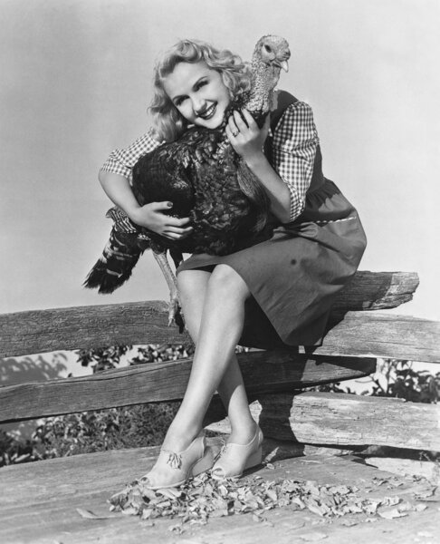 Portrait of woman hugging live turkey