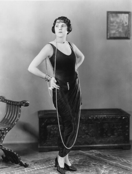 Portrait of woman wearing very long necklace