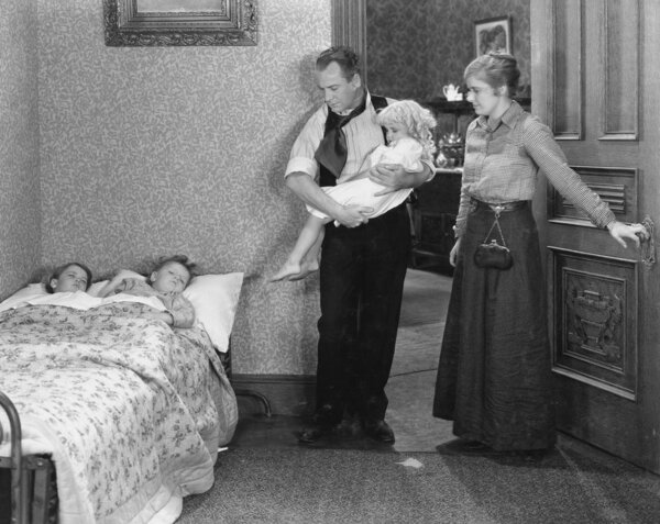 Parents with children at bedtime